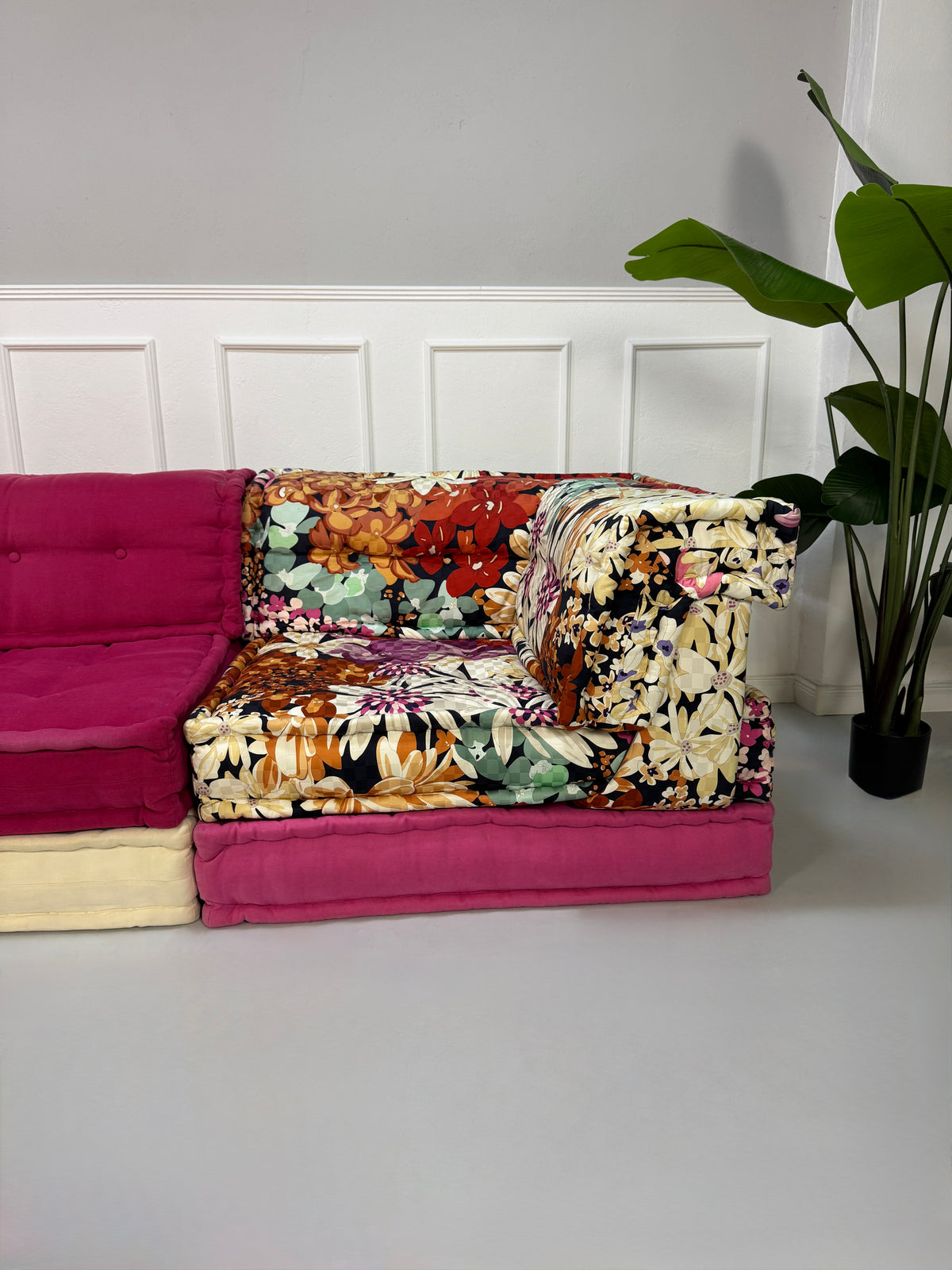 Gebrauchtes buntes Roche Bobois Mah Jong Designer Stoff Sofa vor einer Wand, stilvoll und modern eingerichtet.