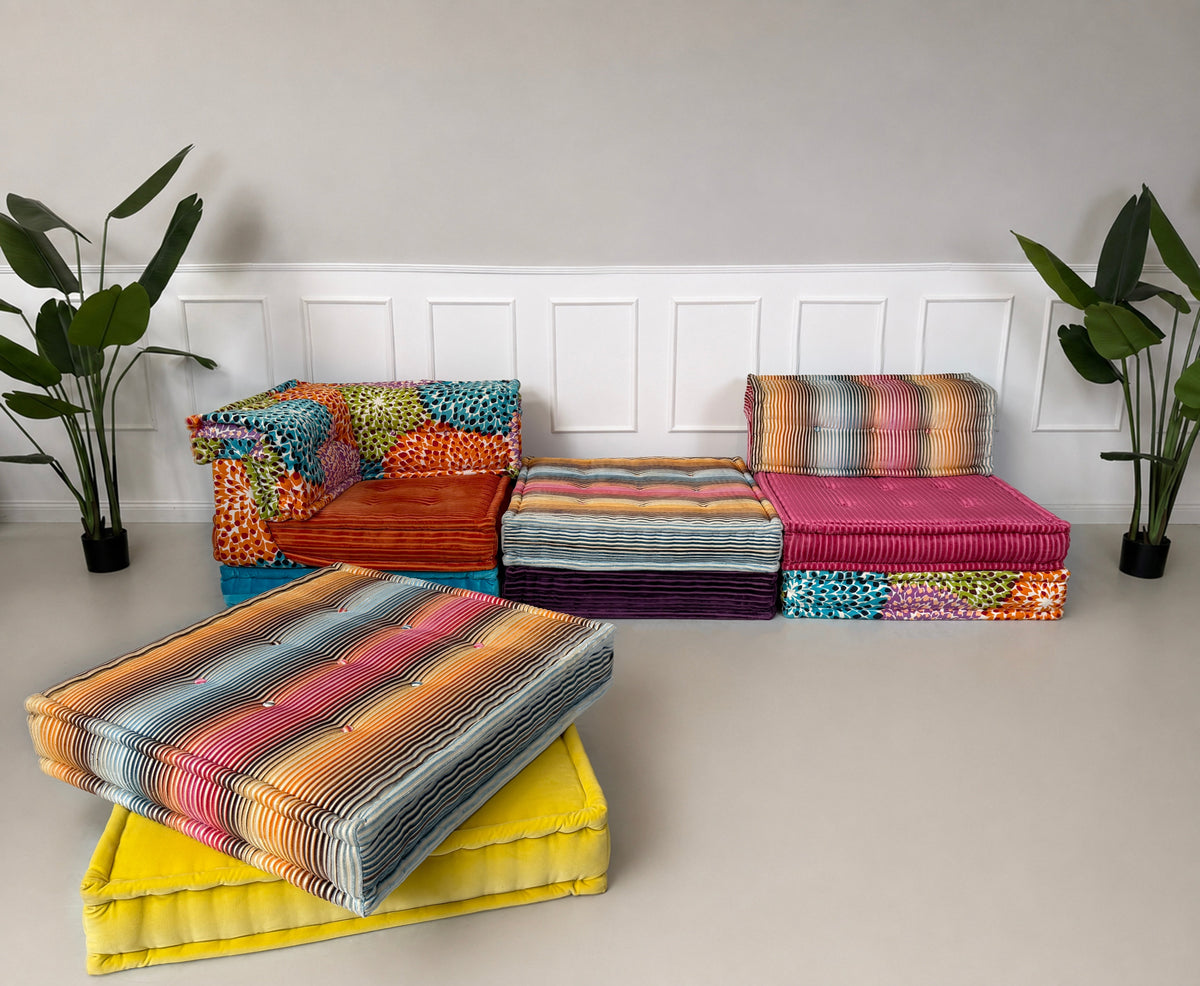 Gebrauchtes buntes Roche Bobois Mah Jong Designer Stoff Ecksofa vor einer Wand, stilvoll und modern eingerichtet.